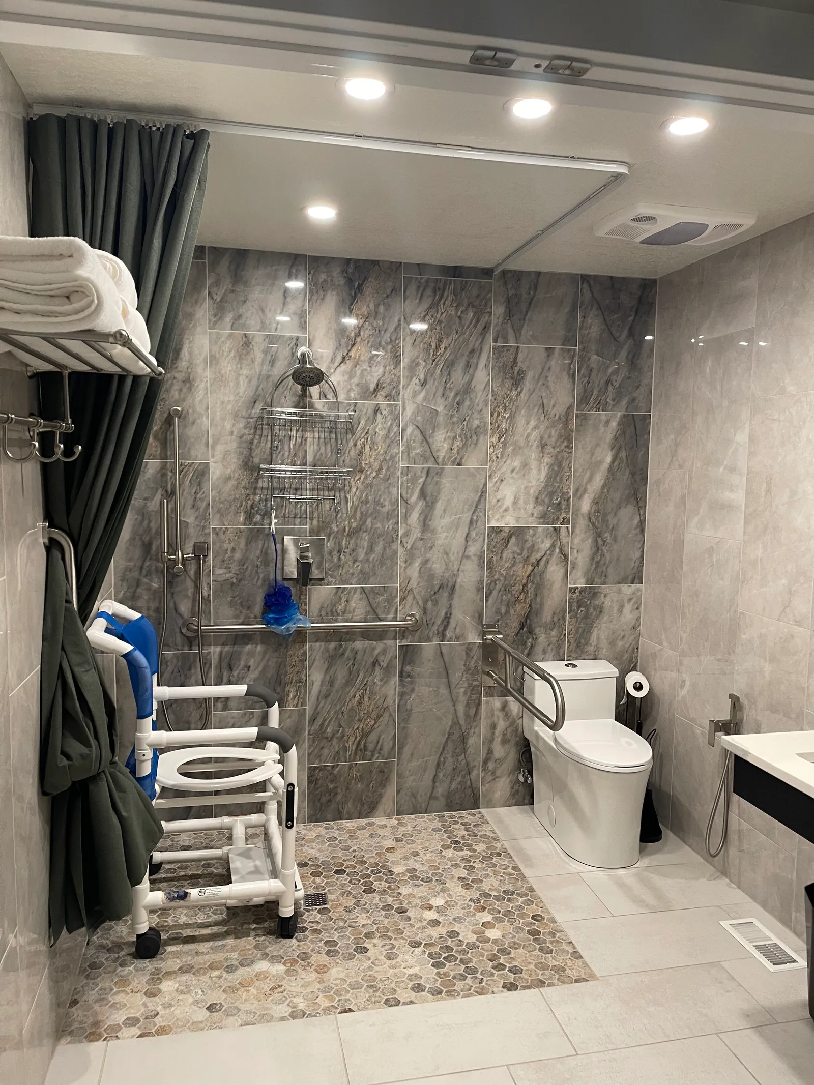 Accessible bathroom at Blue Mountain Residential Care Home in Oregon City with roll-in shower, grab bars, and shower chair